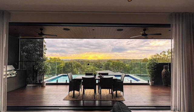 Sunsets views by the infinity pool overlooking a Koala Eucalyptus Reserve. in Murrumba Downs